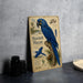 a vintage-style metal sign with a blue parrot illustration, placed on a table next to some black camera lenses.