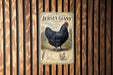 A vintage-style poster of a Jersey Giant chicken is displayed on a wooden wall.