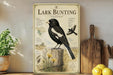 A vintage-style poster of a black and white bird, likely a buntling, is displayed on a wall next to a wooden cutting board and some kitchen utensils.