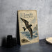 a vintage-style poster or book cover with a bird illustration, placed on a table next to some black camera lenses.