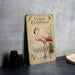 A vintage-style poster of a pink flamingo standing in a body of water, with text and illustrations related to the species.