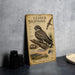 A metal sign displaying information about the Lesser Night Hawk, a bird species, with an illustration of the bird and additional text.