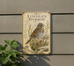 a vintage-style metal sign with an illustration of a Lincoln's Sparrow perched on a branch, mounted on a wall.