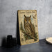 a framed illustration of a long-eared owl, with text and illustrations related to the species.
