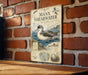 a vintage-style metal sign with illustrations and text, mounted on a brick wall.
