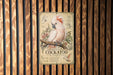 a metal sign with a detailed illustration of a cockatoo, surrounded by various text elements.