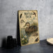 a vintage-style metal plaque or book titled "Mottled Duck" with illustrations of ducks and plants, placed on a gray countertop next to a stack of black camera lenses.