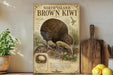 a vintage-style poster of a brown kiwi bird, with a detailed illustration of the bird and its natural habitat. The poster is displayed on a shelf next to a wooden cutting board and a potted plant.