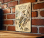 a vintage-style metal plaque with illustrations and text about the Northern Flicker, a bird species.