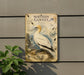 a sign for the Northern Gannet, a bird species, mounted on a wall.