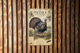 A poster of an ostrich, specifically a wild turkey, is displayed on a wooden wall.