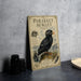 a metal plate with an illustration of a parakeet, along with text and a bird illustration.