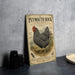 A vintage advertisement for Plymouth Rock chicken, featuring a detailed illustration of a Plymouth Rock chicken standing in a field.