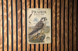 a poster of a peregrine falcon, which is a bird of prey known for its incredible speed and agility. The poster is mounted on a wooden wall, and it appears to be a decorative piece rather than a photograph.