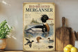 a poster of a red-breasted merican, a type of bird, displayed on a shelf next to a wooden cutting board and some lemons.
