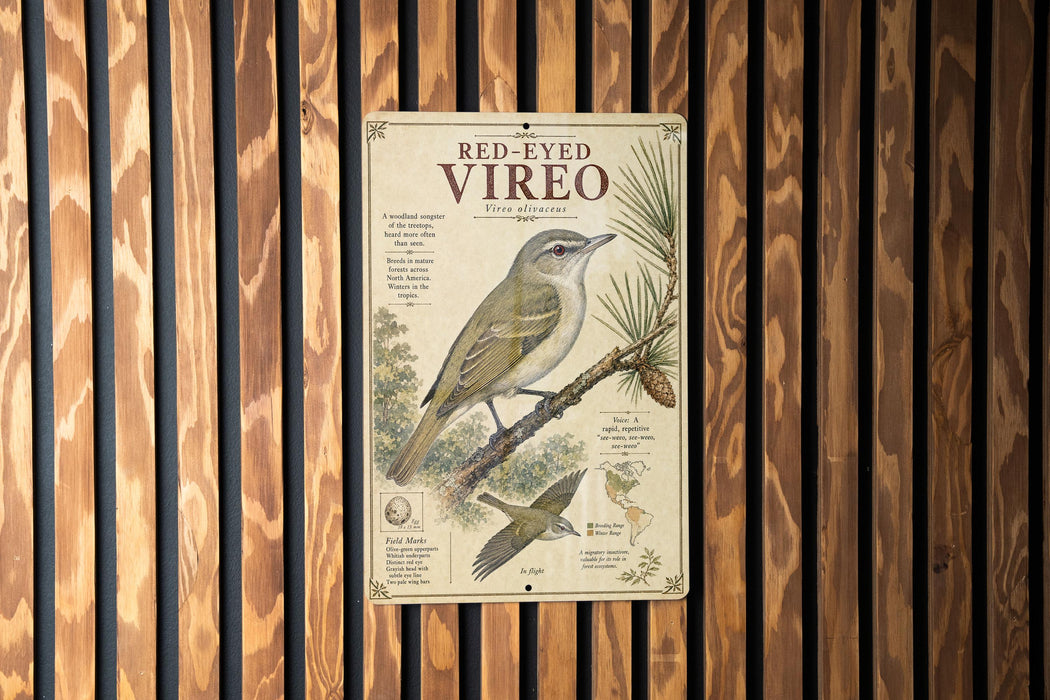 a metal sign with a bird illustration, mounted on a wooden wall.