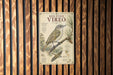 a metal sign with a bird illustration, mounted on a wooden wall.