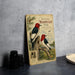 A vintage-style metal plaque featuring illustrations of two red-headed woodpeckers perched on tree stumps, with text describing the species.