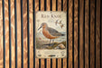 a poster of a red knot bird, which is a type of sandpiper, standing on a beach.