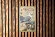 a metal sign with a picture of a seagull, specifically a Red-legged Kittiwake, standing on a rock.