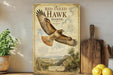 a poster of a red-tailed hawk soaring over a mountainous landscape, with a potted plant to the left and a wooden cutting board to the right.
