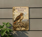 a vintage-style sign with a red-tailed hawk perched on a rock, surrounded by a natural landscape.