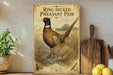 A vintage-style metal sign featuring a colorful illustration of a ring-necked pheasant standing in a field, with a wooden paddle and a potted plant in the background.