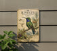 a vintage-style metal sign with illustrations of a hummingbird and various plants, mounted on a wall.