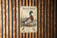 a sign with an illustration of a roen duck, mounted on a wooden wall.
