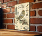 a vintage-style metal sign with illustrations and text about the Ruby-crowned Kinglet, a small bird native to North America.