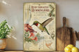a vintage-style book cover for "Ruby-throated Hummingbird at Feeder" by North American Songbirds, with illustrations of a hummingbird feeding from a feeder and surrounded by flowers. The book cover also includes text and a map of the United States.