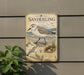 A metal sign with a vintage-style illustration of a sanderling bird, along with additional bird illustrations and text, is mounted on a wall.