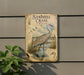 a vintage-style sign depicting a sandhill crane in a wetland environment, with illustrations of the crane, plants, and other wildlife.