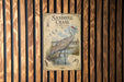 A vintage-style metal sign with an illustration of a sandhill crane in wetlands, mounted on a wooden wall.
