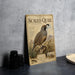 A metal plate with a vintage-style illustration of a scaled quail, featuring detailed text and an illustration of the bird in a desert landscape.