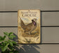 a metal sign with a picture of a sharp-tailed grouse, mounted on a wall.