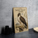a vintage-style metal plate with an illustration of a short-tailed hawk, placed on a table next to some black camera lenses.