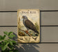a sign with an illustration of a bird, specifically a snail kite, perched on a branch.