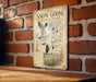 A vintage-style sign with the title "Snow Goose Flock in Flight" is displayed on a brick wall, featuring illustrations of snow geese in flight.