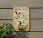 A vintage-style sign depicting a flock of snow geese in flight, with a plant in the foreground.