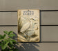 a vintage-style sign with a white egret illustration, mounted on a wall next to a plant.
