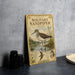 A vintage-style metal plate with illustrations and text about a solitary sandpiper bird, placed on a countertop next to some black camera lenses.