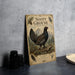 a wooden sign with a detailed illustration of a black grouse bird, surrounded by various natural elements such as pine trees and mountains.