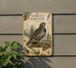 a vintage-style metal plaque with a detailed illustration of a pine grouse, a type of bird, perched on a branch surrounded by pine trees and foliage.