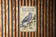 a vintage-style metal sign with a white-crowned pigeon illustration, mounted on a wooden wall.