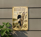 a vintage-style metal sign with illustrations of a white-headed woodpecker and pine trees, mounted on a wall.