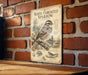 a vintage-style metal sign with illustrations and text, mounted on a brick wall.