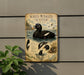 a sign depicting a white-winged scoter, a type of water bird, with illustrations of the bird in flight and swimming.