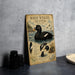 A vintage-style illustration of a white-winged scoter duck, accompanied by detailed text and illustrations, is displayed on a wall.