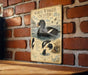 a vintage-style metal sign with illustrations and text, mounted on a brick wall.